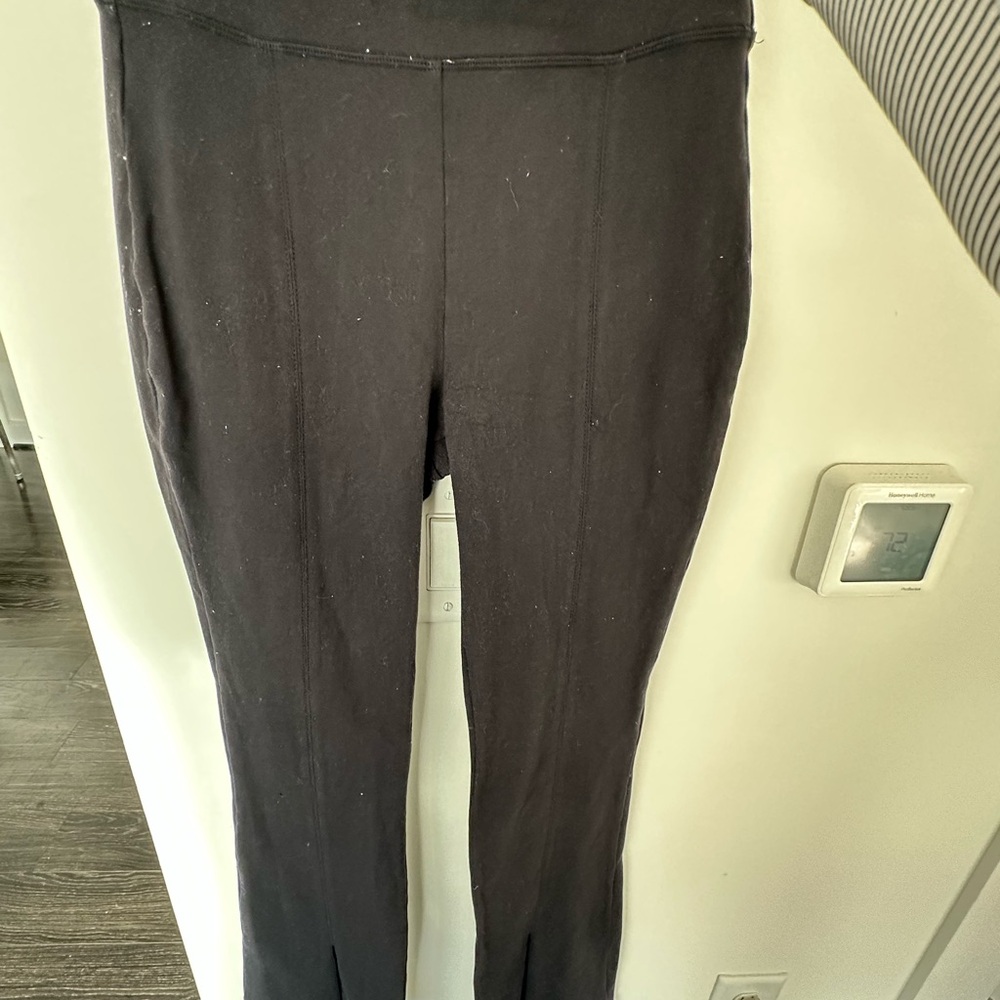 ALO Yoga Black Leggings, flare and split at bottom.